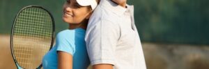Happy Couple Posing on Tennis Court Man and Woman Posing with Tennis Rackets