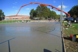 Bunnell High School- Installing Post Tension Cables and Concrete Concrete being poured onto a tennis court