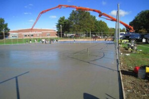Bunnell High School- Installing Post Tension Cables and Concrete Concrete being poured onto a tennis court